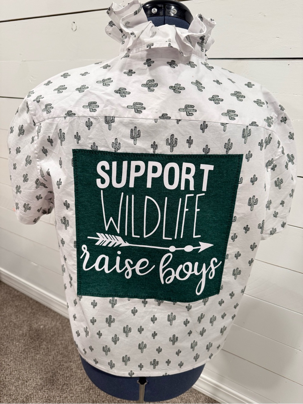 George White Short-Sleeve Top with Green Patch "Support Wildlife Raise Boys"
